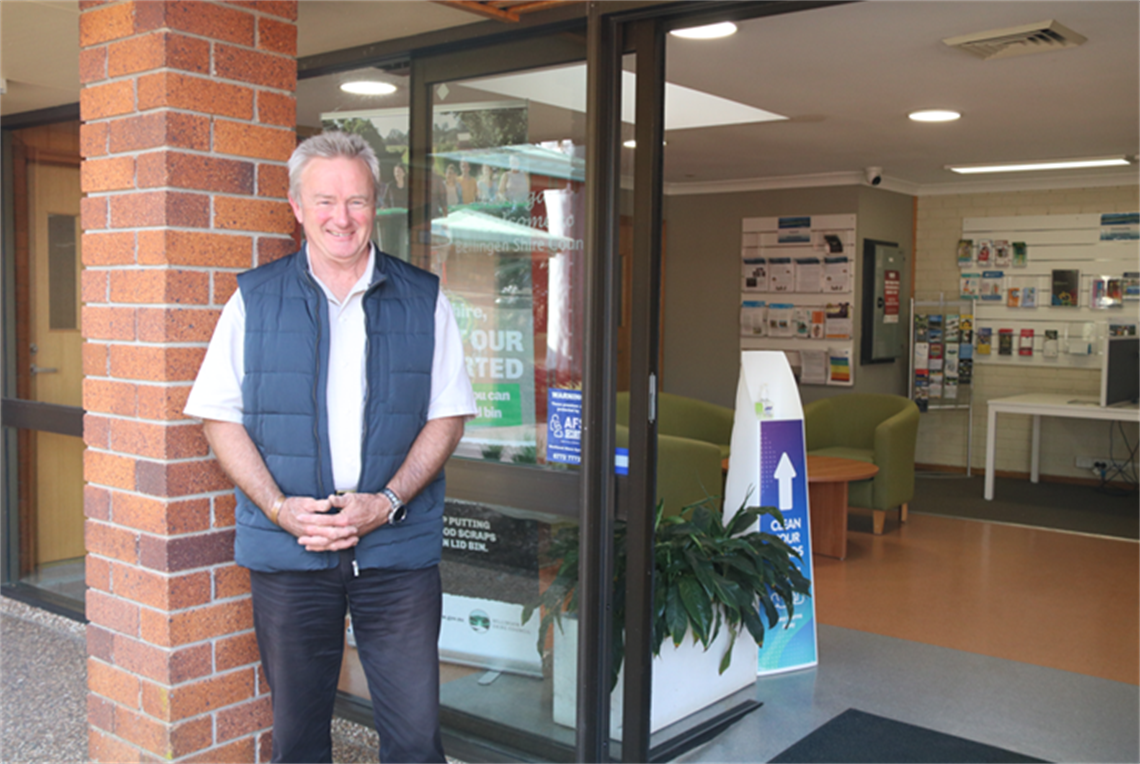Cr Shepard standing in front of the Council building smiling