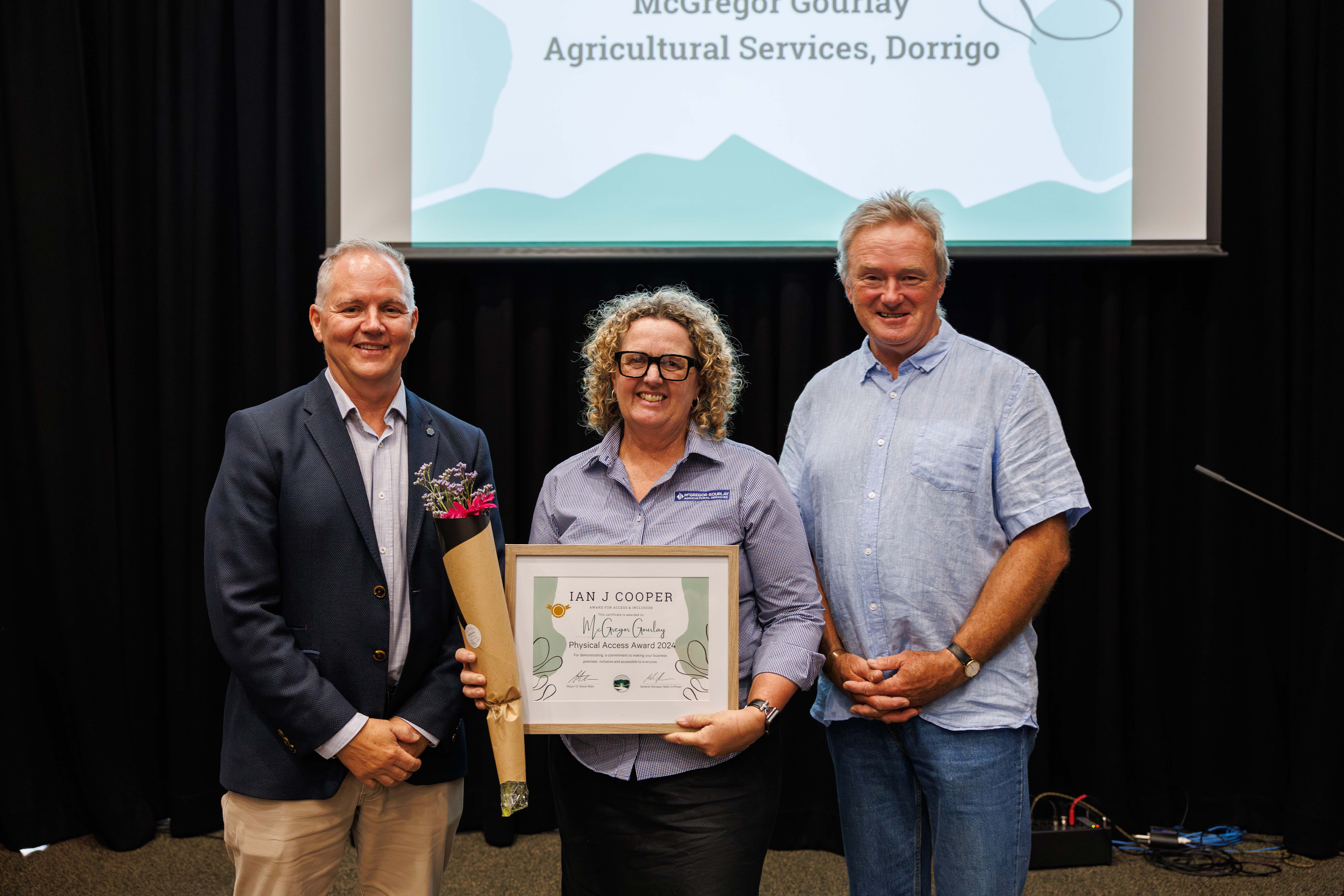 Kylie Raymond accepting award on behalf of McGregor Gourlay with Mayor Cr. Steve Allan and Cr. Graeme Shephard (Jay and The Trees Photography)